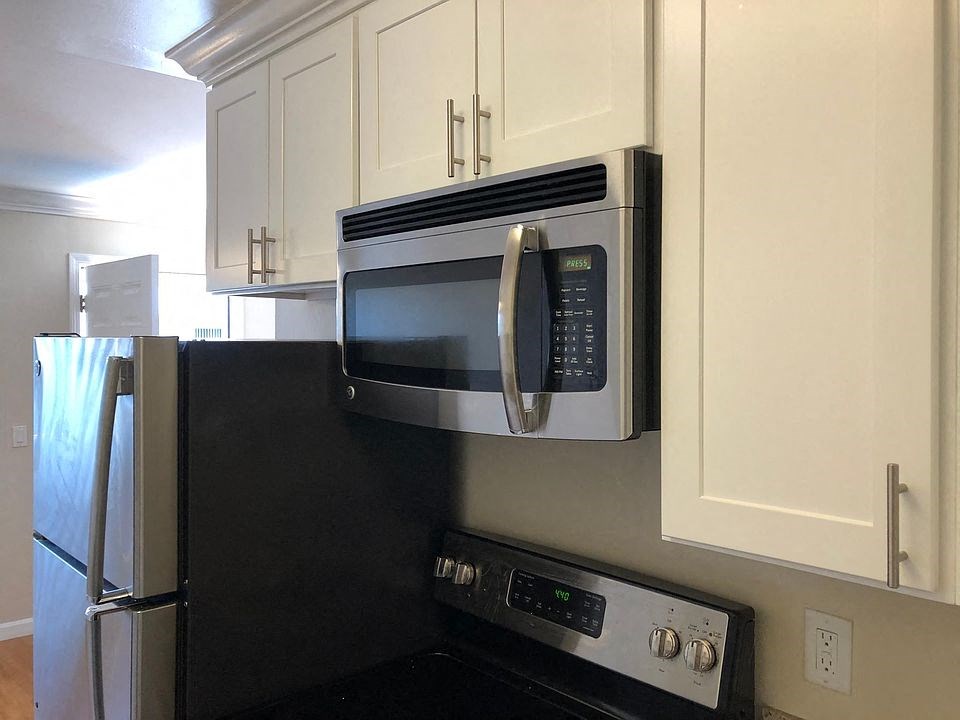 a kitchen with a microwave and a refrigerator