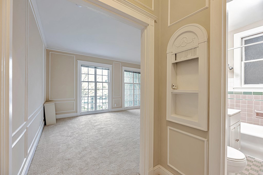 A white bathroom with a toilet and sink.