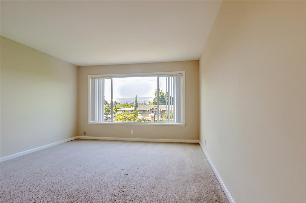 a spacious living room with a large window