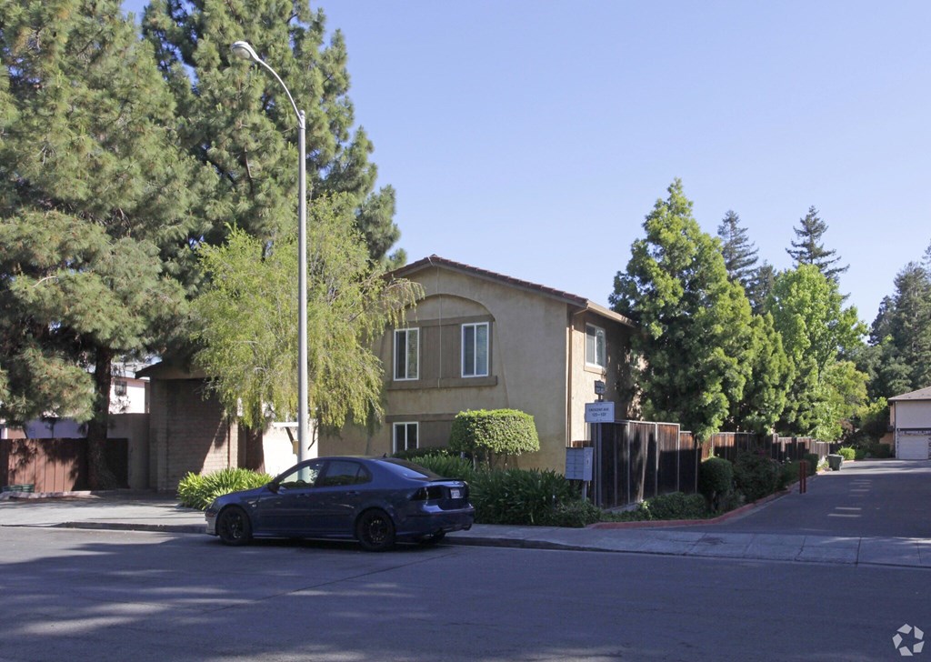 A blue car is parked on the side of a street.