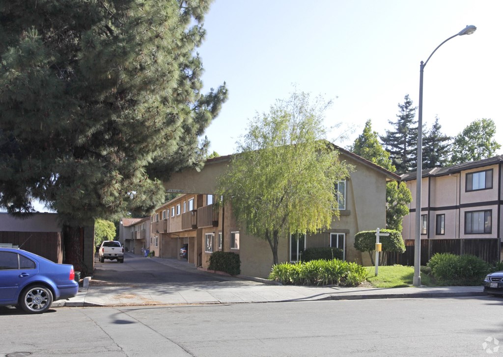 A blue car is parked on the side of a street.