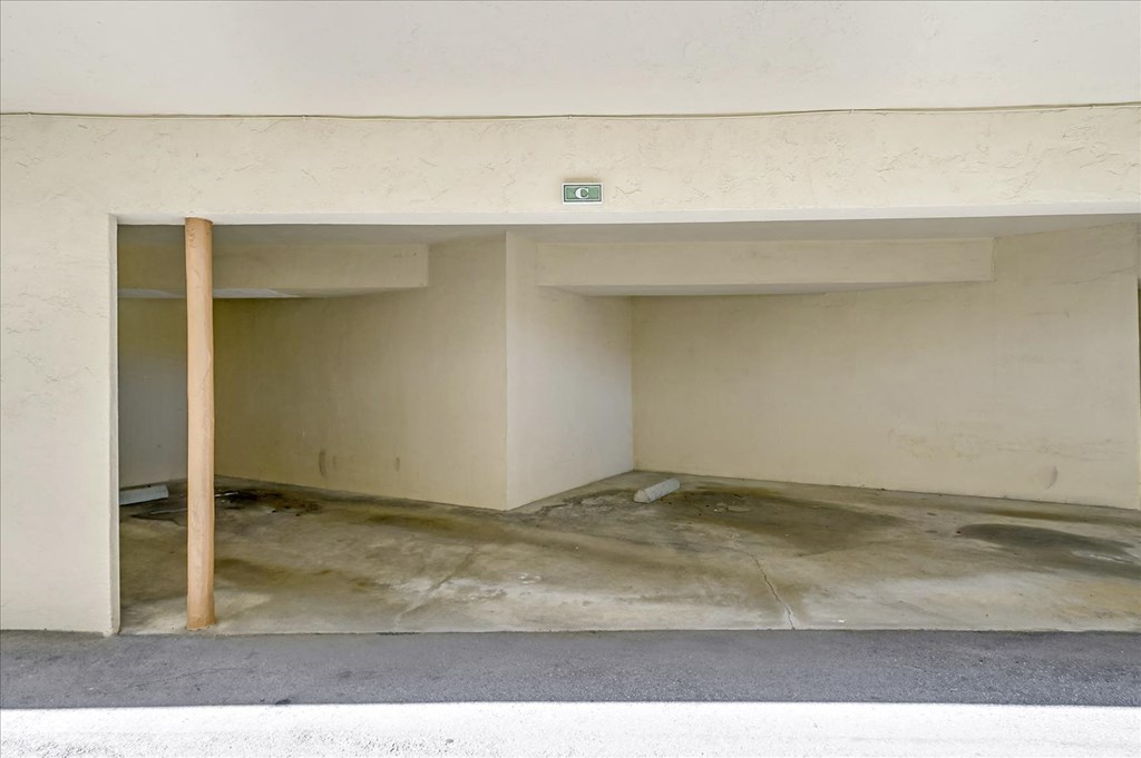 the inside of a parking garage with a pole