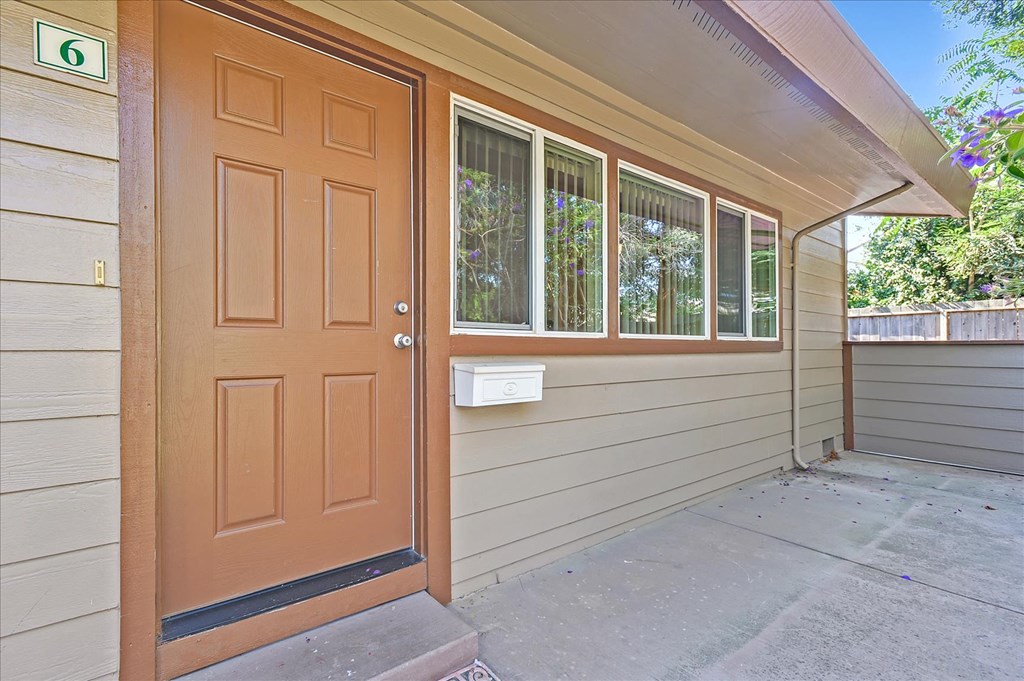 a front door of a home with a porch