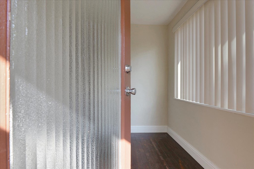 an empty room with a door and a window