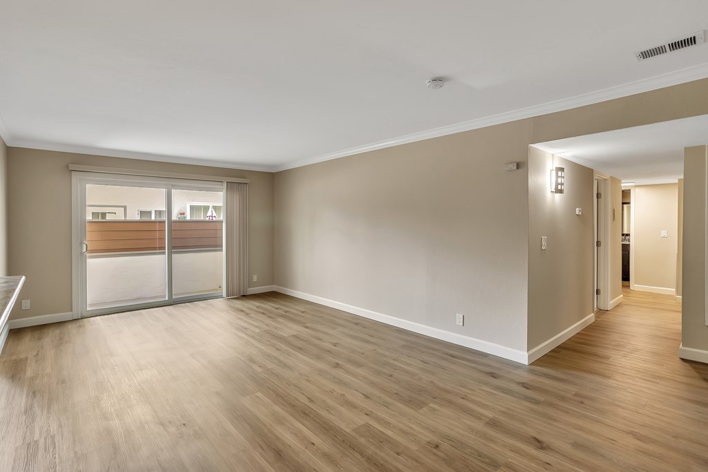 A room with wooden floors and white walls.