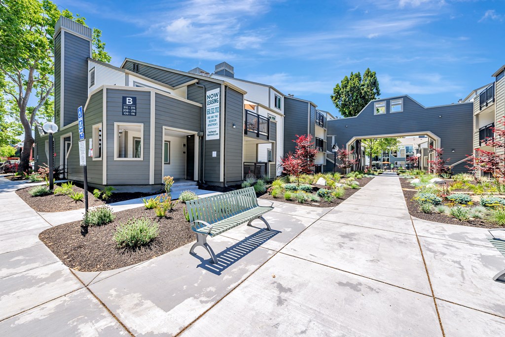 A modern building with a bench in front of it.