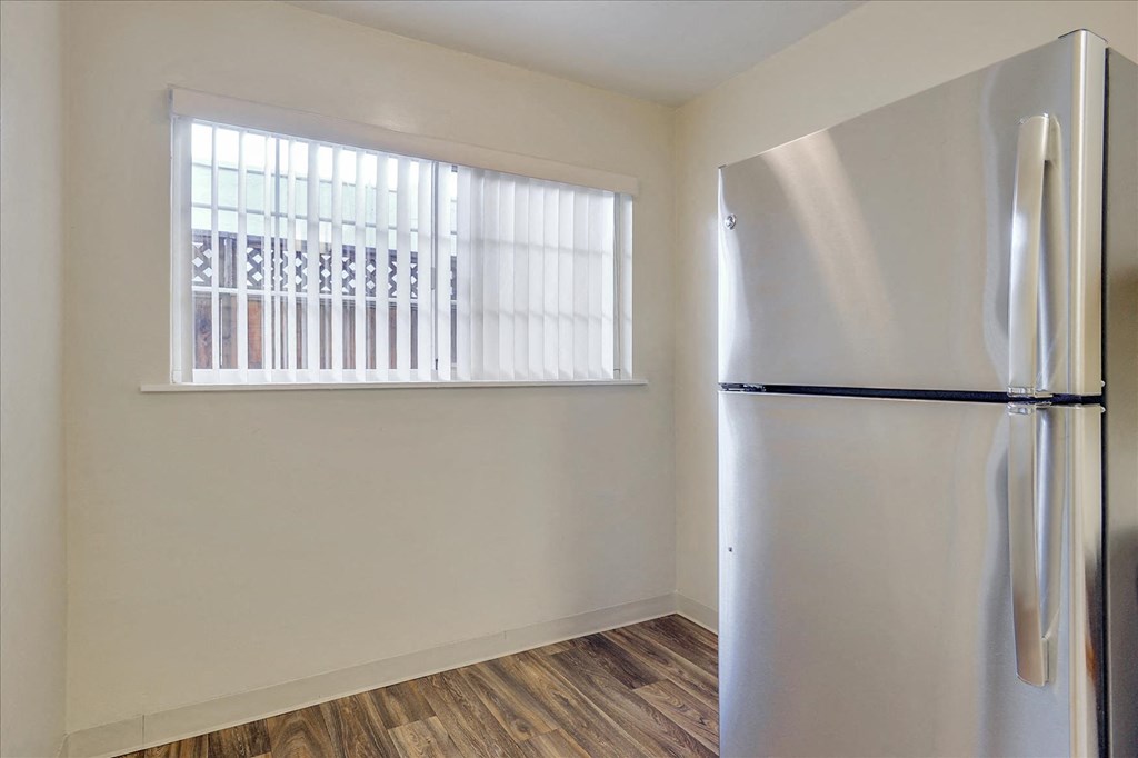 a kitchen with a refrigerator and a window
