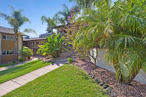A well-maintained garden with a variety of plants and trees.