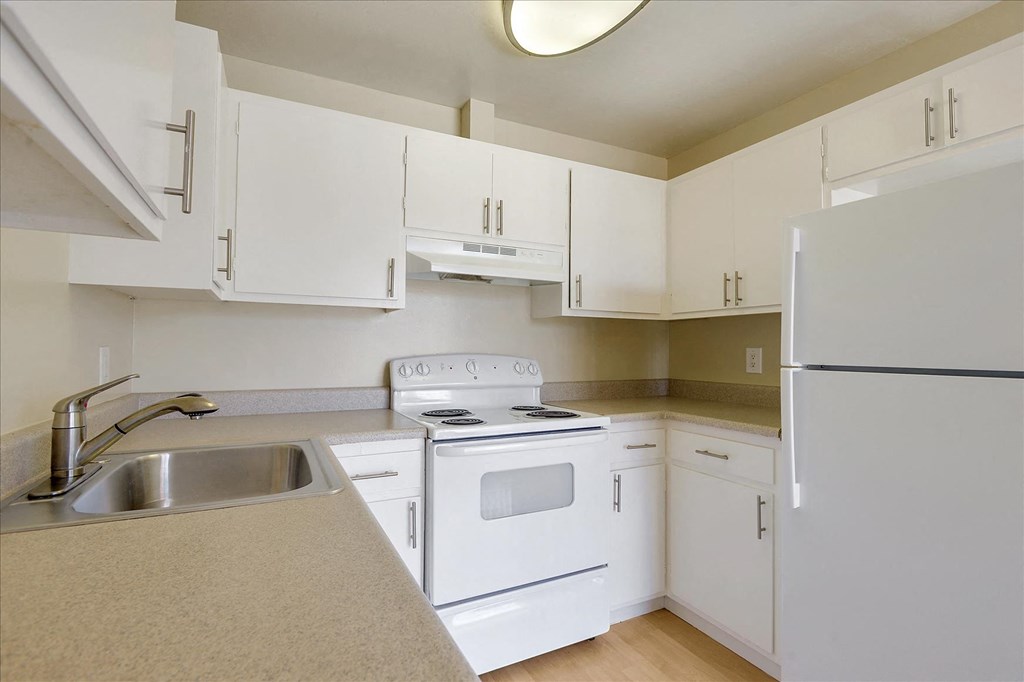 a kitchen with white appliances and white cabinets