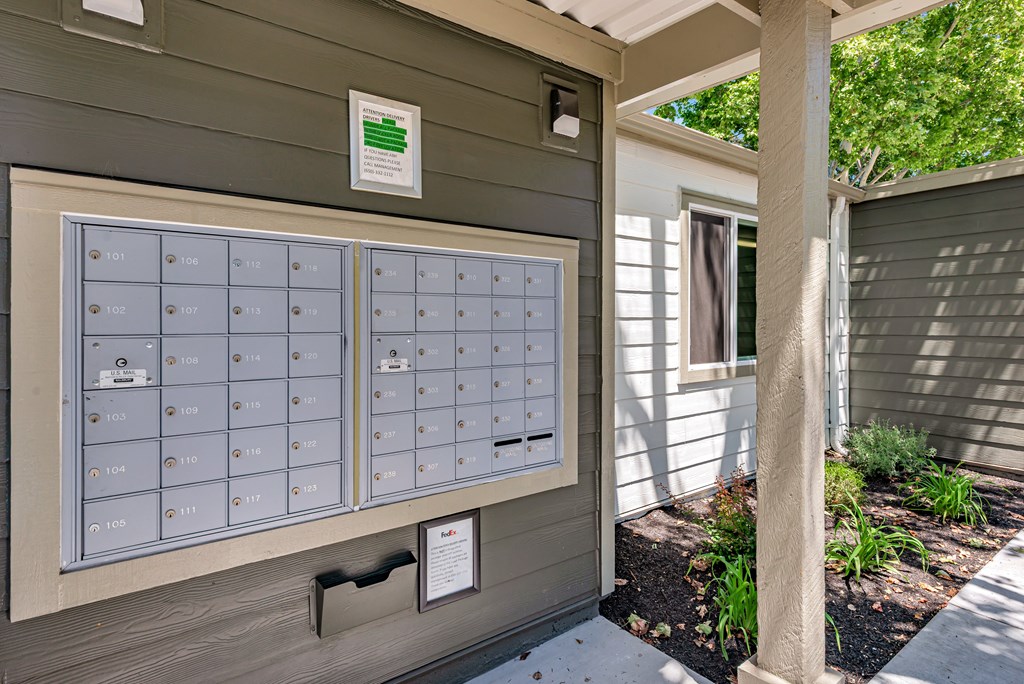 A mailbox with the number 101 on it is on the side of a building.
