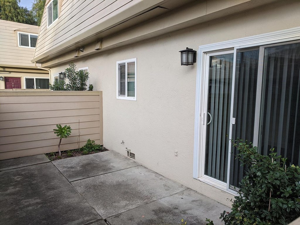a patio outside of a house with a glass door