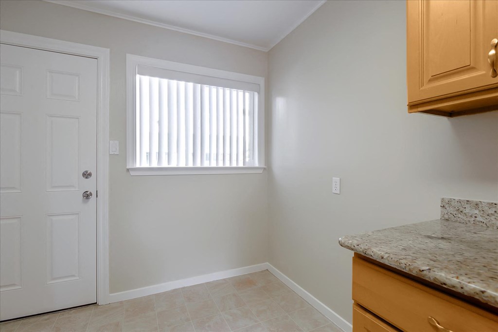 A room with a door, window, and countertop.