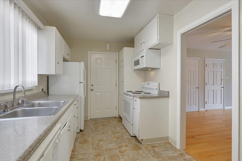 a kitchen with white cabinets and a sink