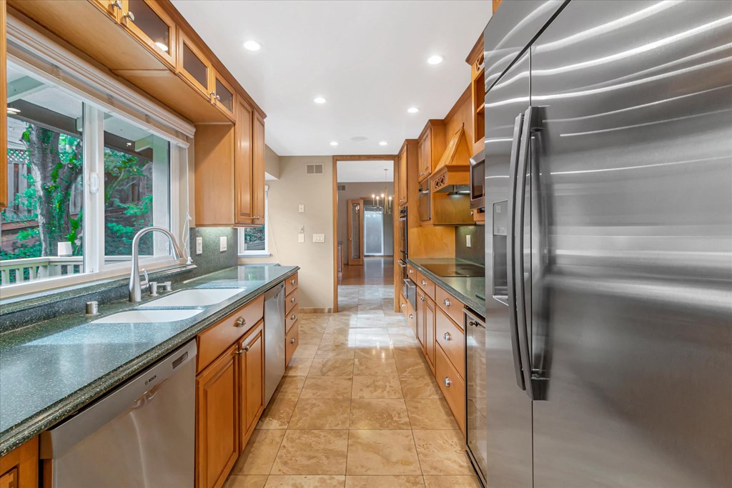a large kitchen with stainless steel appliances and counter tops