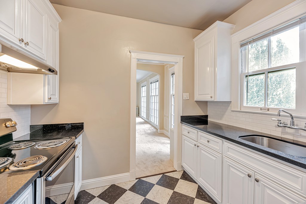 A kitchen with black and white checkered floor.