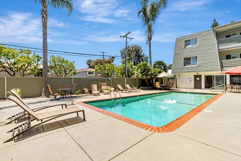 A pool with a red border and a slide in the middle.