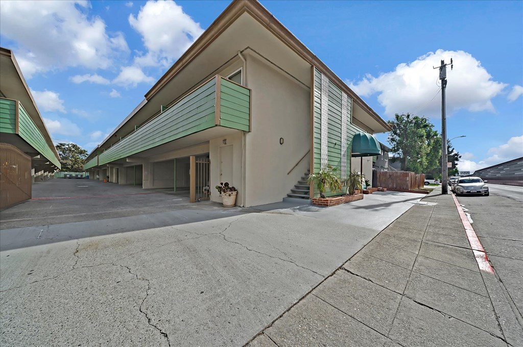 A building with a green awning is shown in the image.