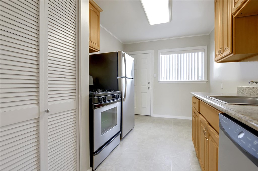 A kitchen with a black refrigerator and stove.