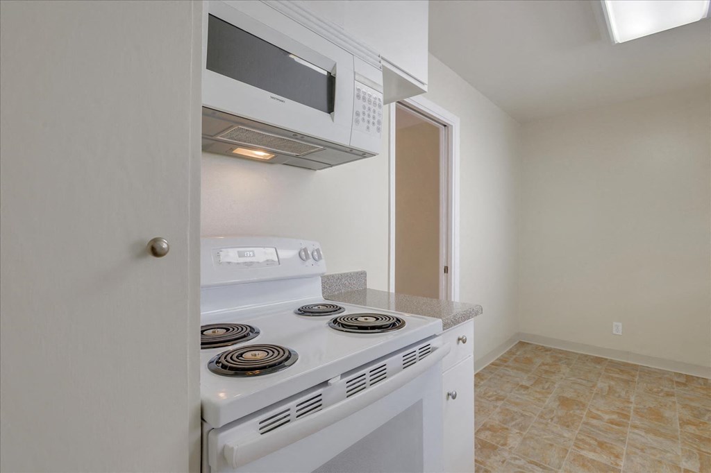 a kitchen with an oven and microwave and a stove