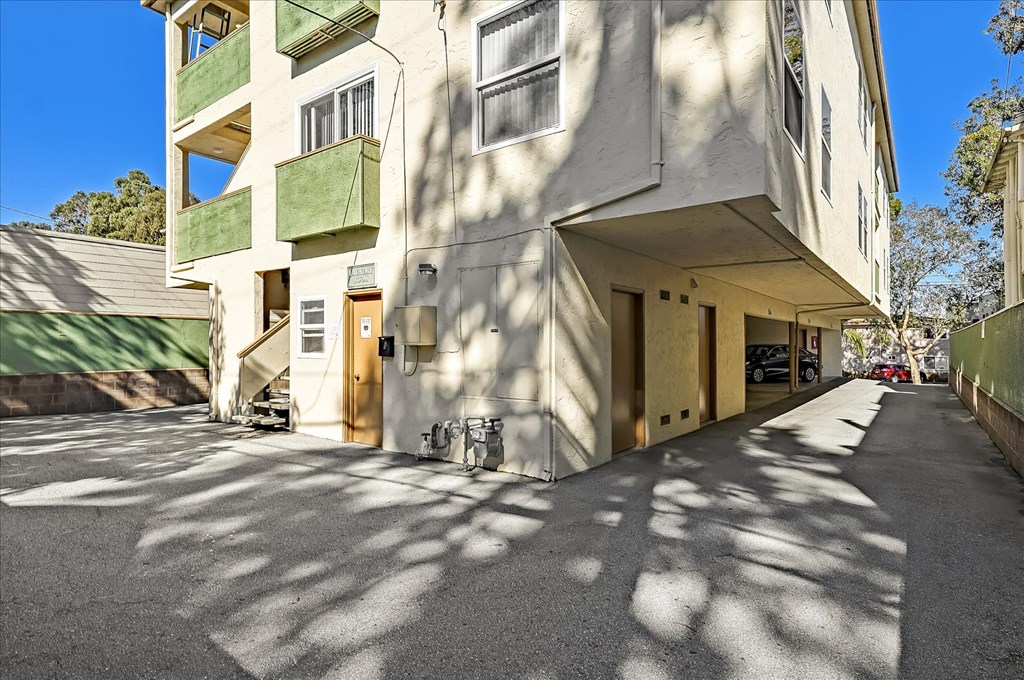 the building has a long driveway and a parking garage