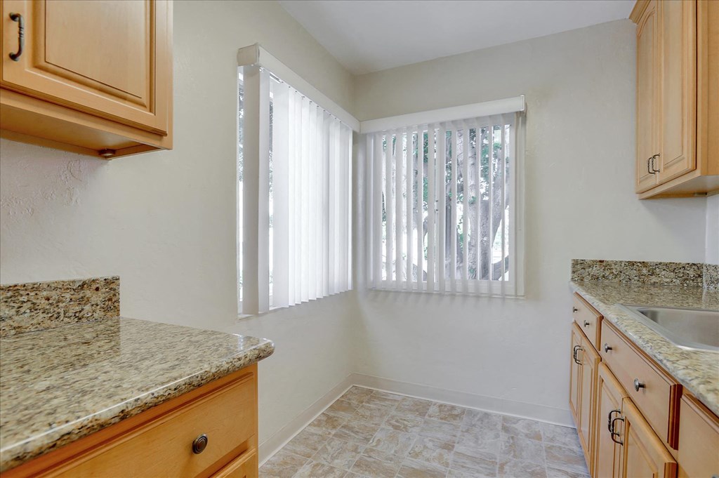 a kitchen with granite counter tops and a window