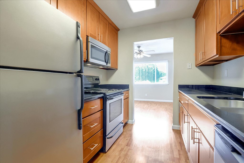 a kitchen with stainless steel appliances and wooden cabinets