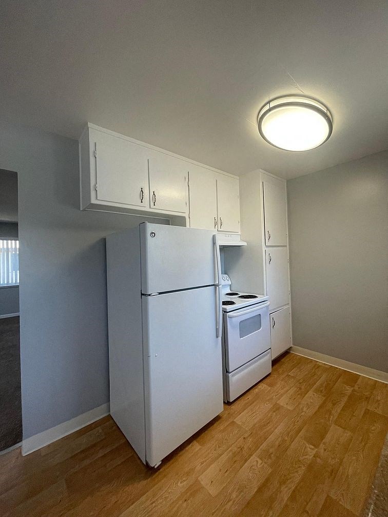a kitchen with a refrigerator and a stove