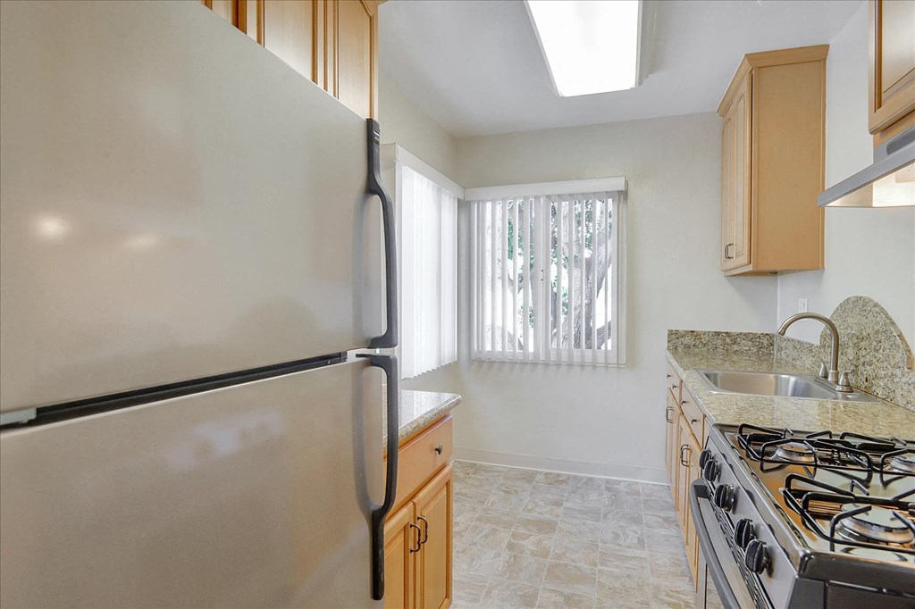 a kitchen with a stove and a refrigerator
