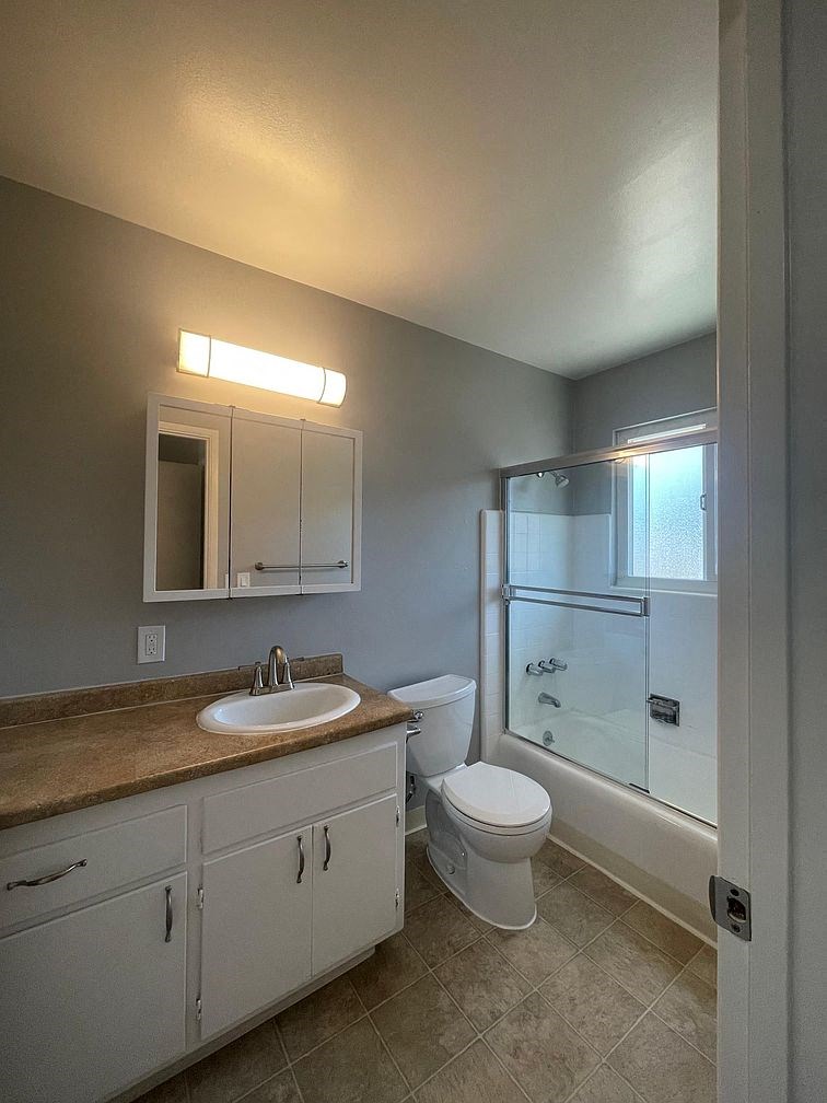 a bathroom with a sink toilet and a shower