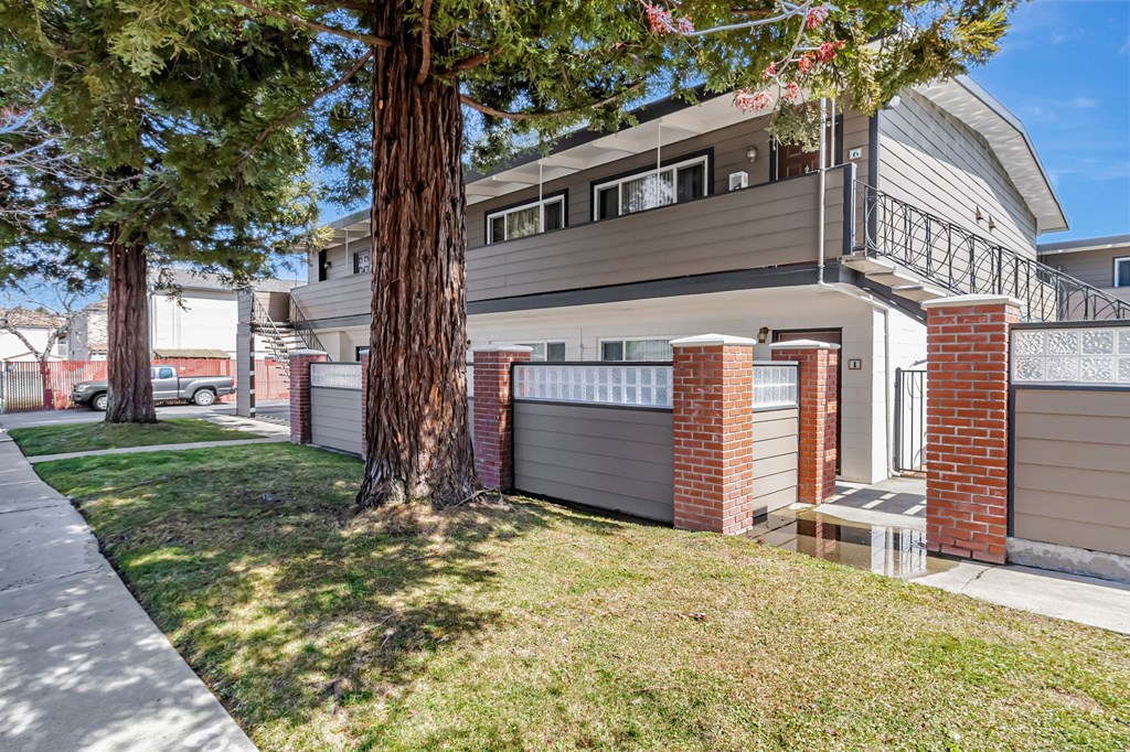 A building with a brown tree in front of it.