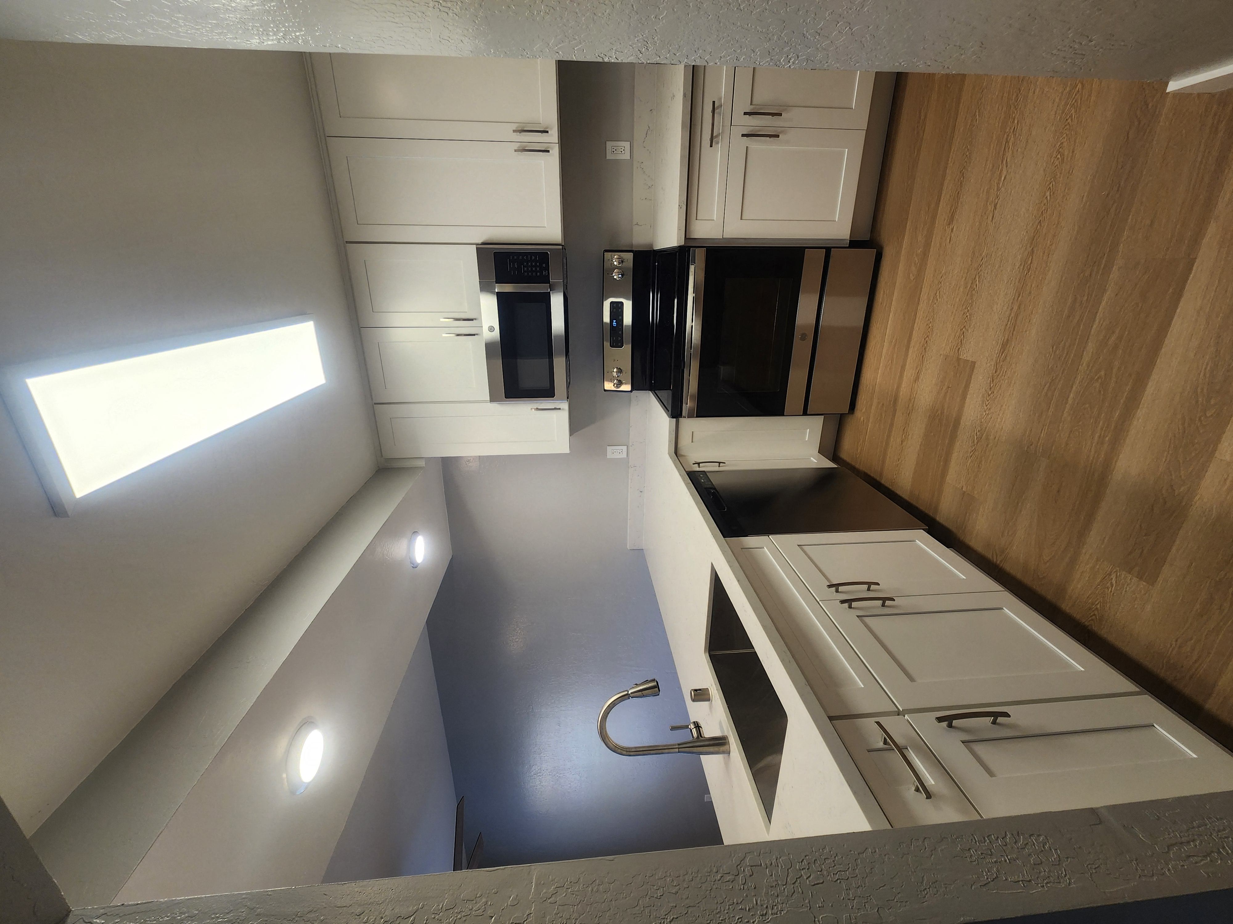 an overhead view of a kitchen with white cabinets and a counter top