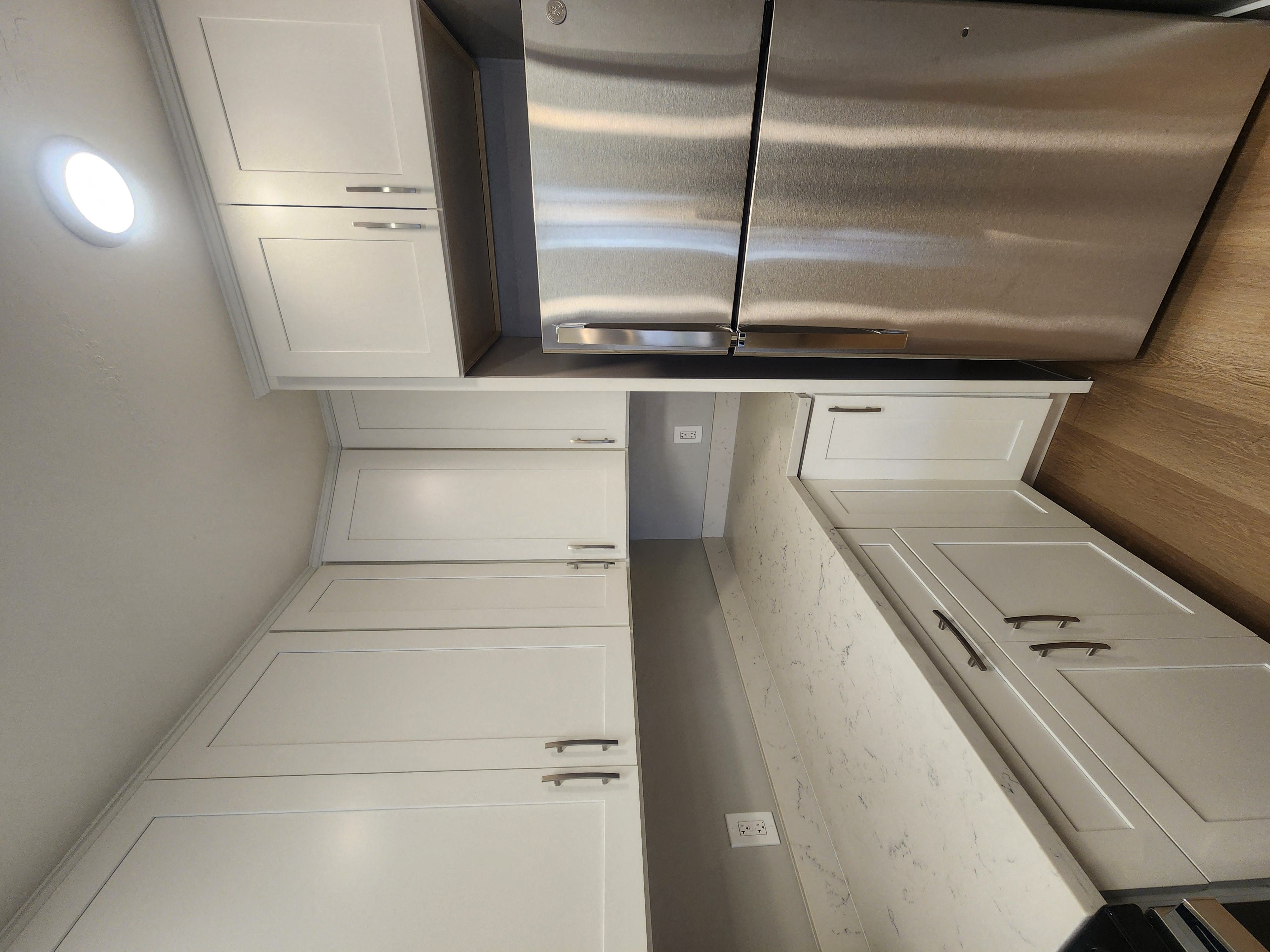 a kitchen with white cabinets and stainless steel appliances