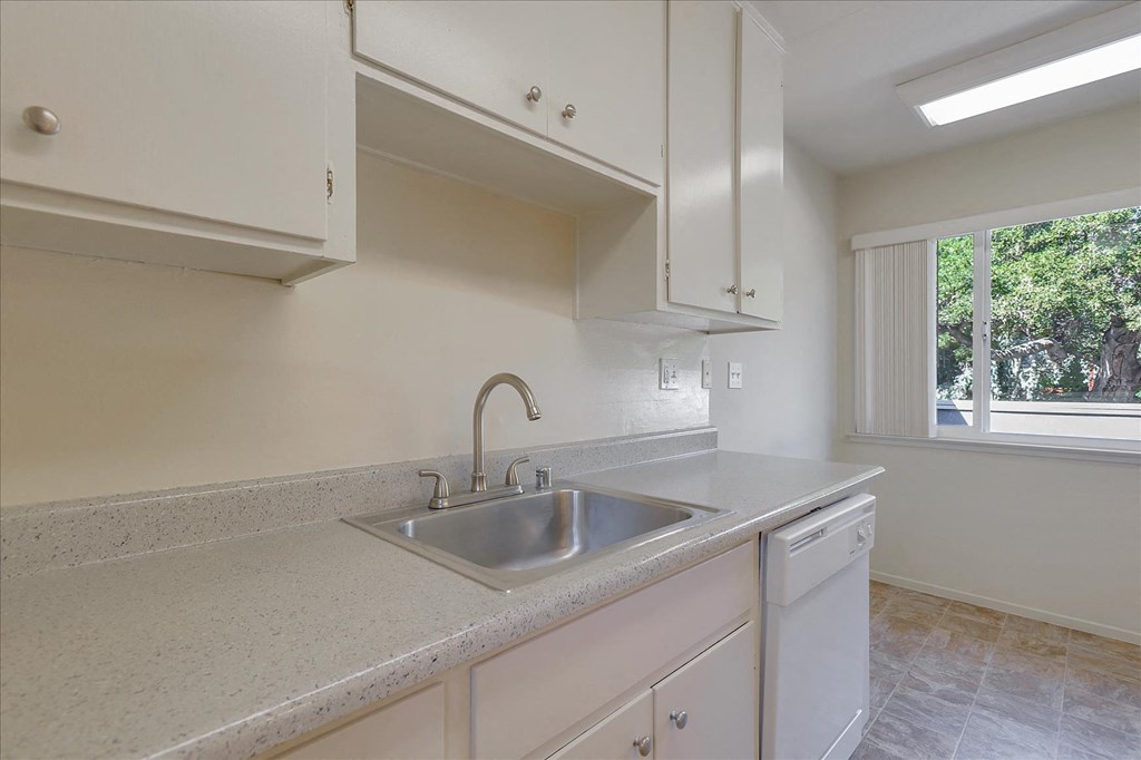 A kitchen with a sink and a window.