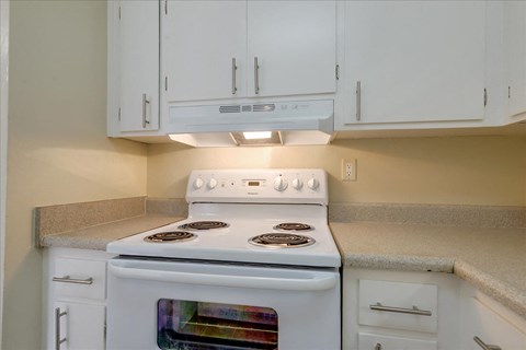 a kitchen with white appliances and white cabinets