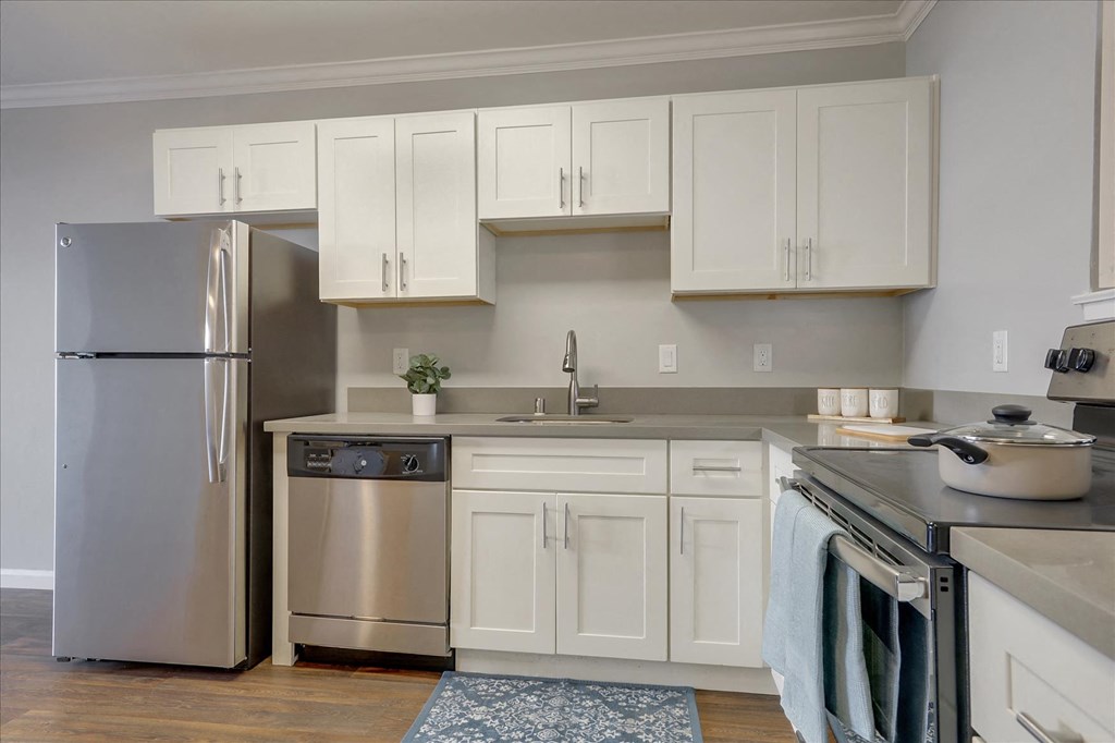 a kitchen with stainless steel appliances and white cabinets