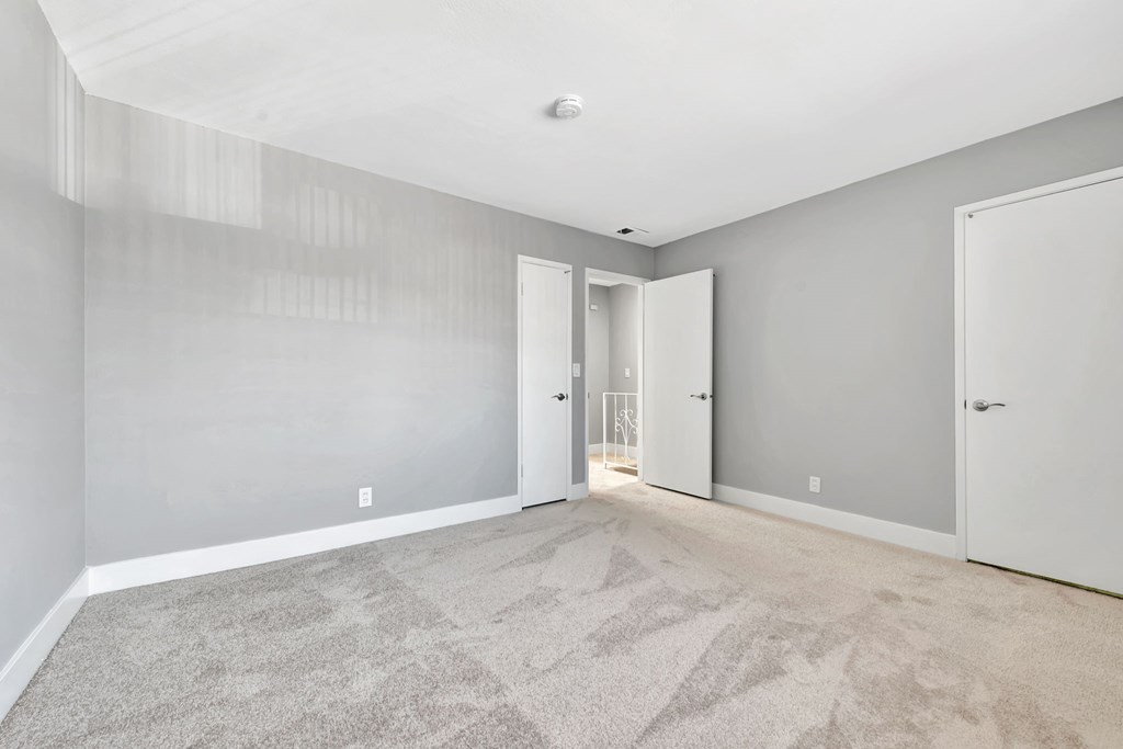 A room with grey walls and a carpeted floor.