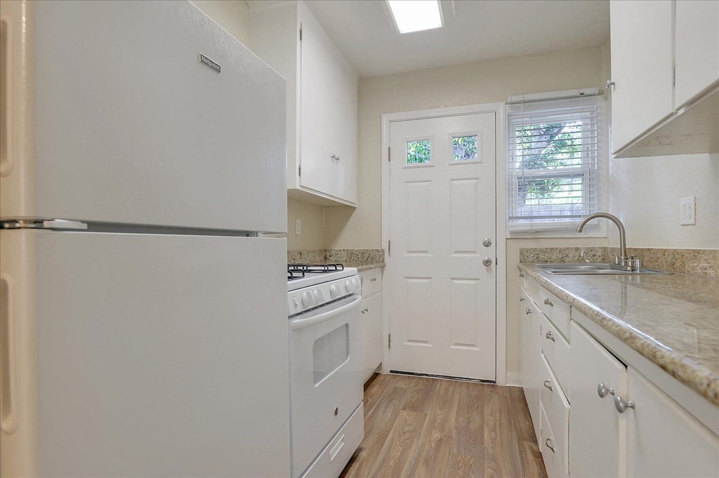 a kitchen with white appliances and white cabinets
