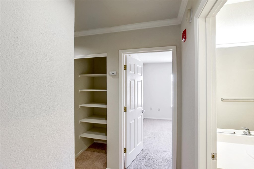 A white door is open to a bathroom.