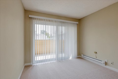 the spacious room with sliding glass doors to the patio