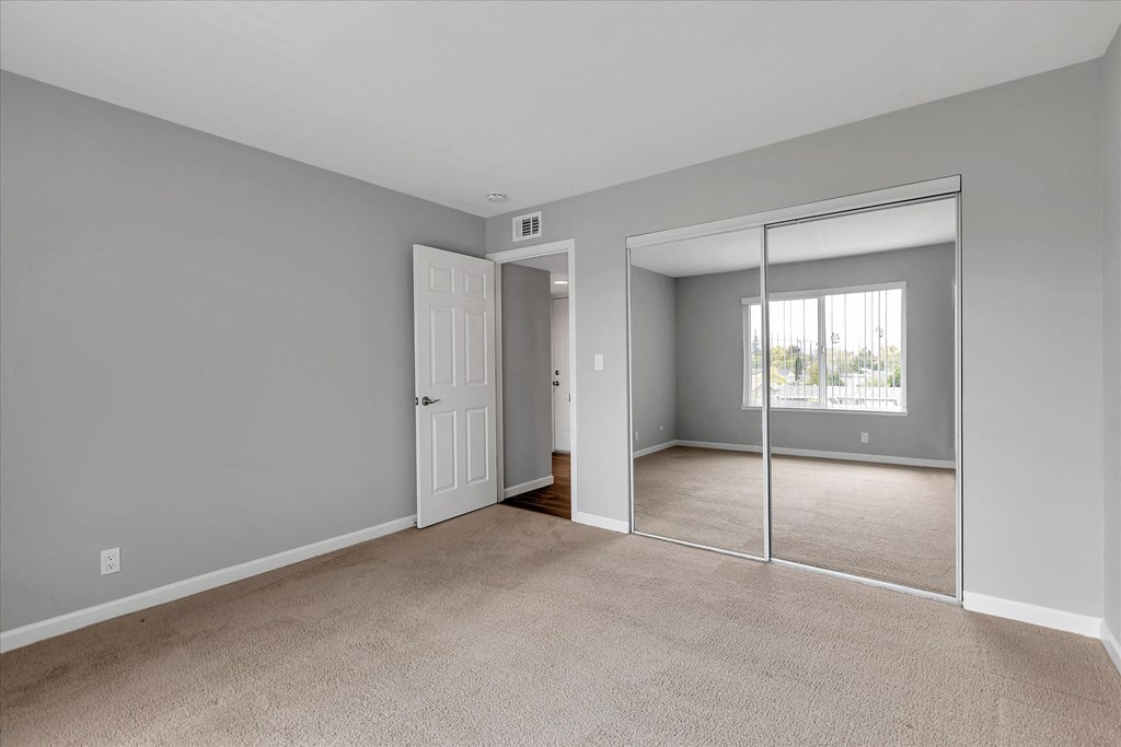 Bedroom with large closet and mirrored doors