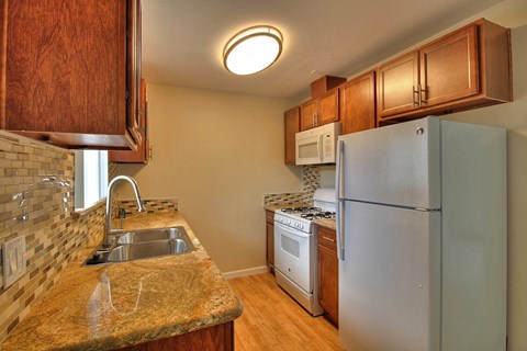 a kitchen with a sink and a refrigerator