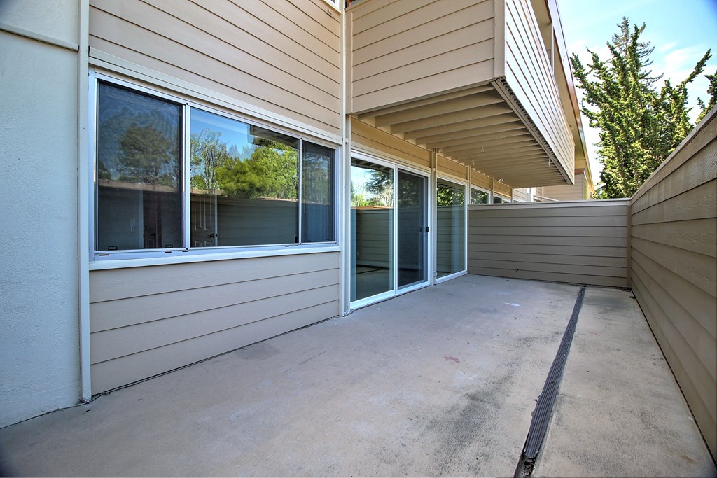 the covered patio of a home has been cleaned and is empty