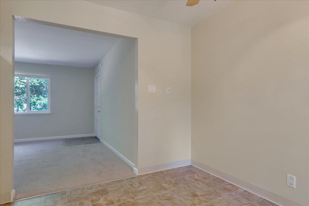 A room with a tiled floor and a window.