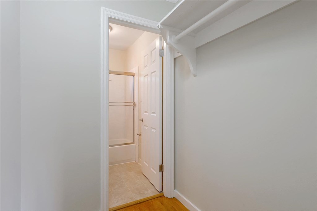 A white door is open to a hallway.