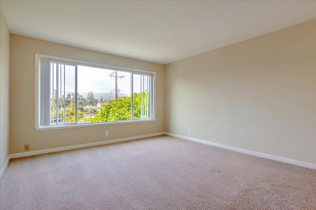 an empty living room with a large window