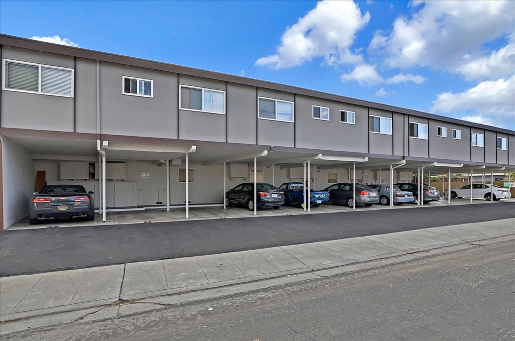 a parking garage with cars parked in front of it