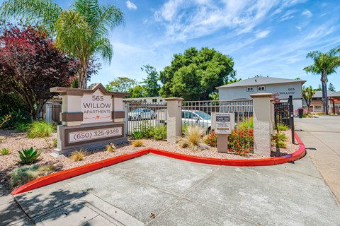 The image shows the entrance to the Willow Apartments with a sign and a red circular border.