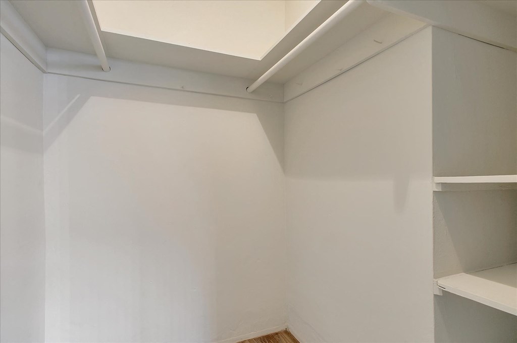 a room with white walls and shelves and a white ceiling