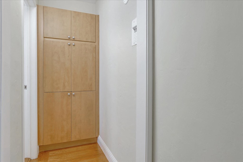 a bedroom with a closet and a door to a hallway