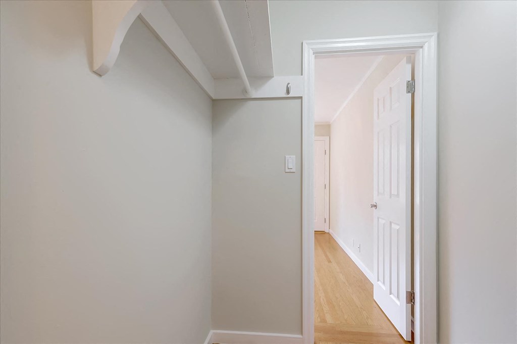 A white door is open to a hallway.